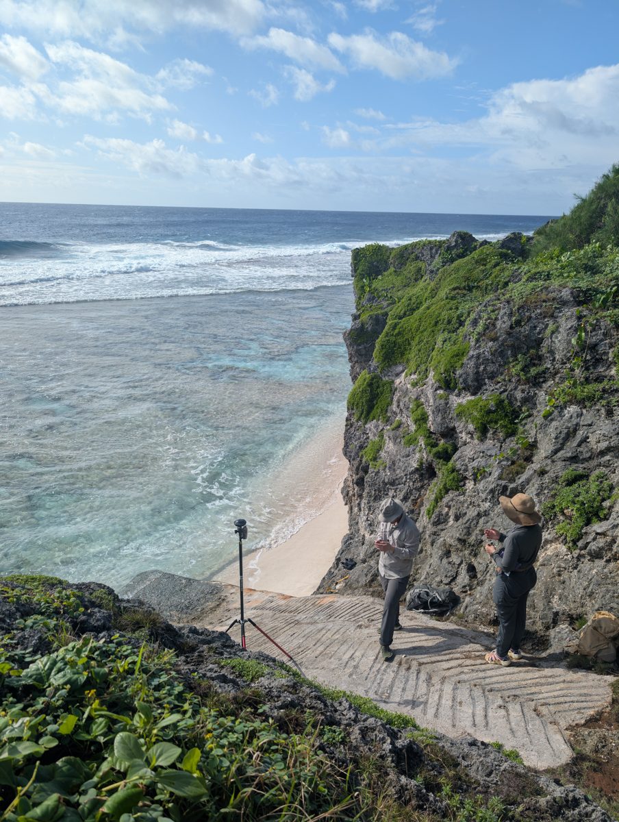 Billy and Tilli record a GPS point midway up the cliff overlooking the modern reef flat.