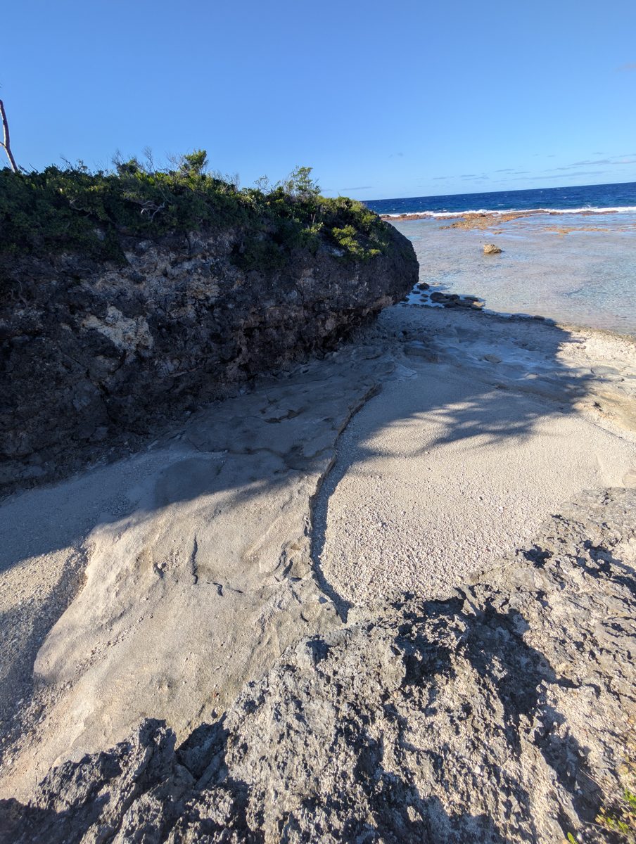 Groove bedrock and sand fill: Photos show bedrock or cemented material in grooves near recent sand fill.